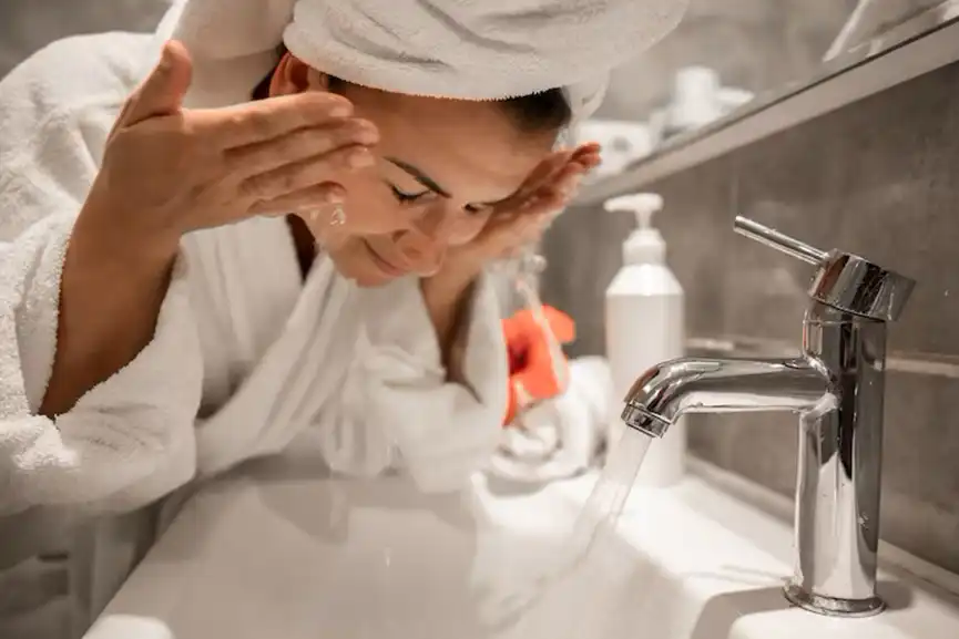 young-beautiful-woman-bathroom-with-towel-her-head-washes-her-face-with-tap-water
