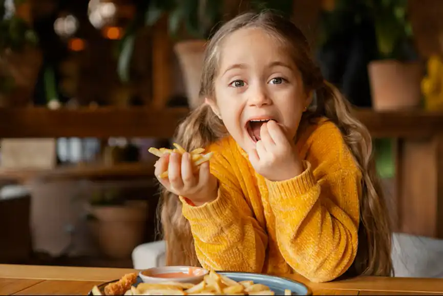 medium-shot-girl-eating-fries