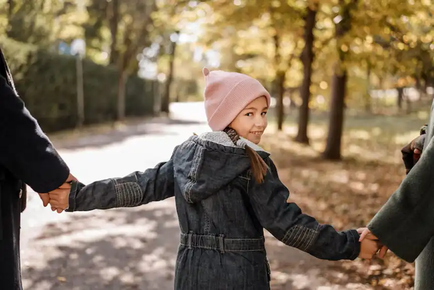 Adoption-girl-holding-parents-hands