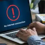 person-works-laptop-with-no-internet-connection-warning-indoor-workspace-social-media-post