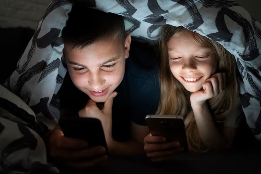 high-angle-kids-with-smartphones-blanket