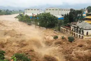 A swollen river surges through Kathmandu