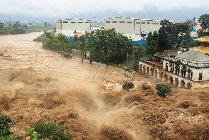 A swollen river surges through Kathmandu