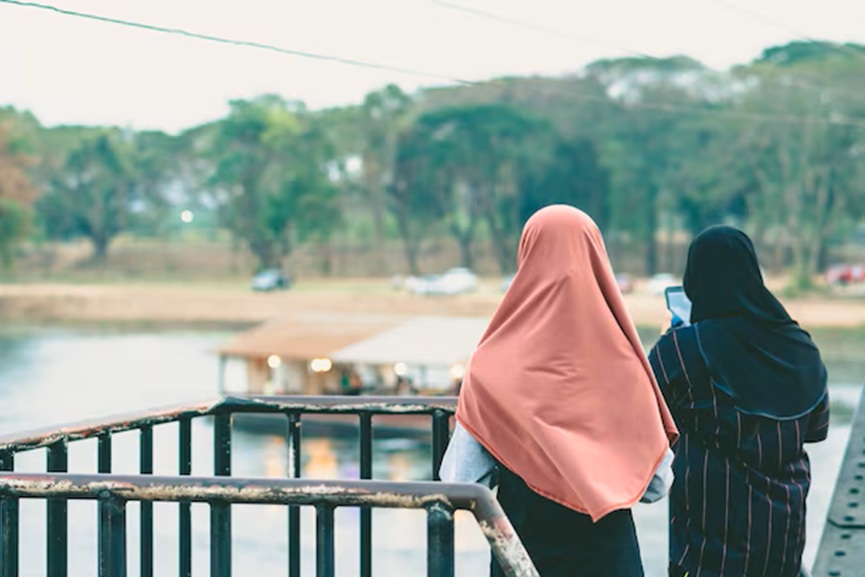 rear-view-women-standing-against-railing