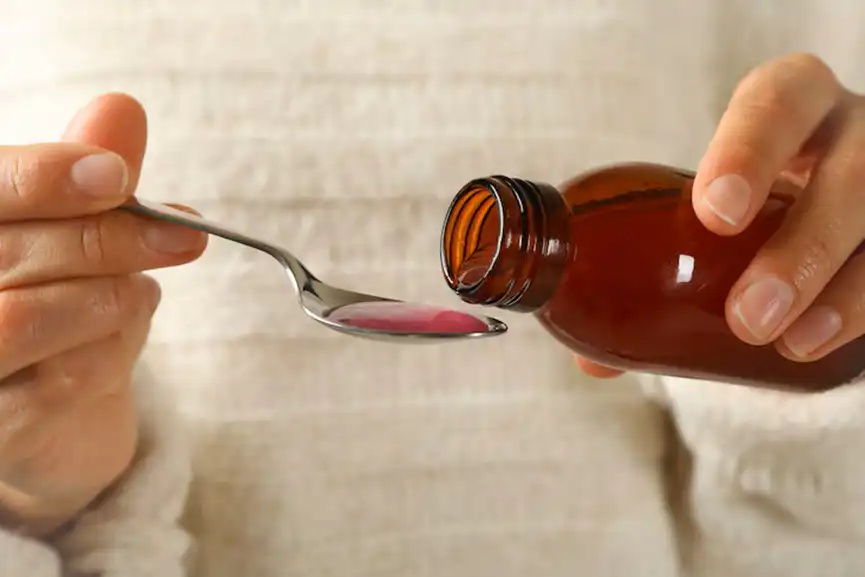 woman-pouring-syrup-spoon