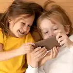 top-view-young-kids-using-smartphone-together