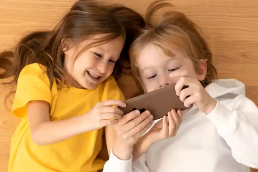 top-view-young-kids-using-smartphone-together