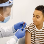 male-doctor-doing-vaccination-multiracional-boy