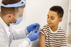 male-doctor-doing-vaccination-multiracional-boy