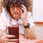 teenager-using-smartphone-floor