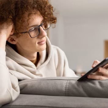 person-reading-online-magazine-using-digital-device