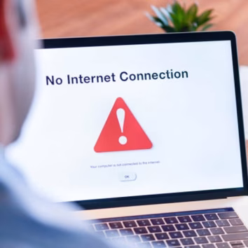 Businessman looking at an internet failure screen on a computer. He is in an office